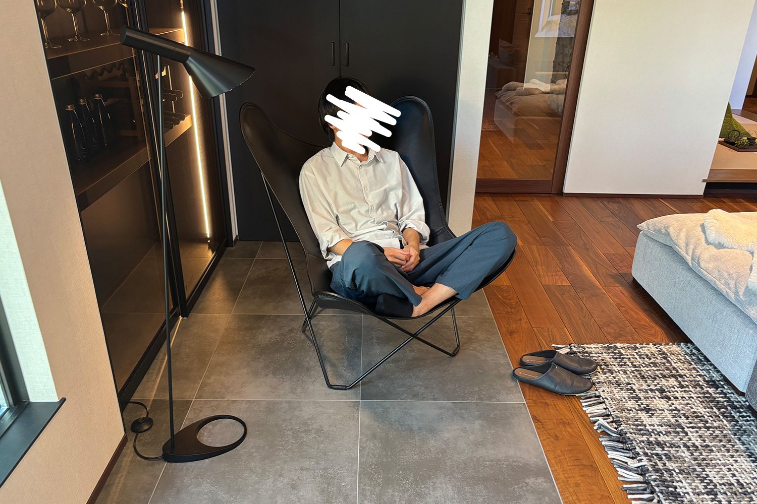 男性がチェアにあぐらをかいて座っている